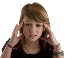 teenager_girl_stressed_headache_istock-1541430068437-300x240.jpg